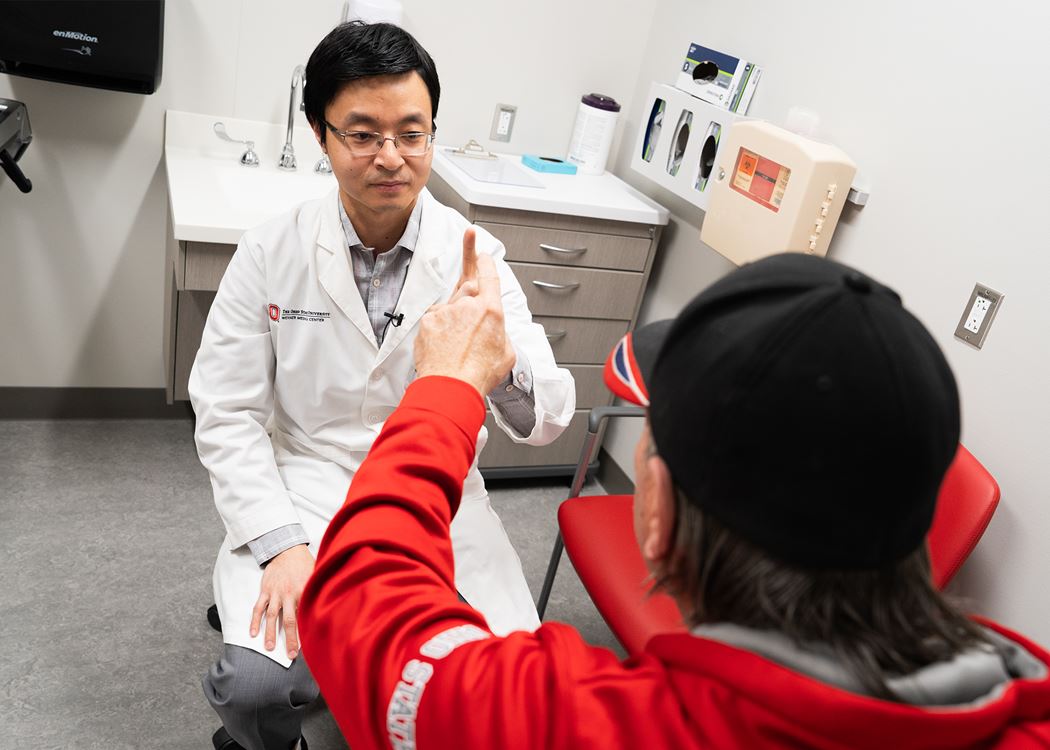 Dr. Yinan Zhang examines a patient in the MS clinic