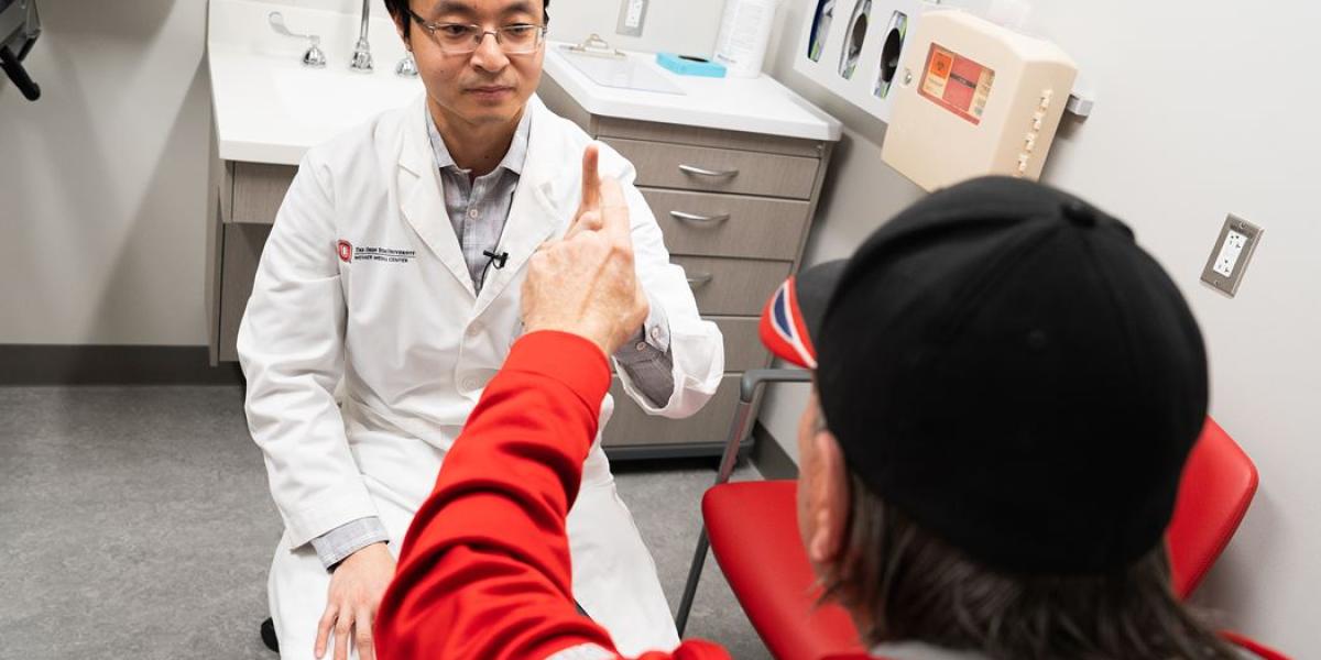 Dr. Yinan Zhang examines a patient in the MS clinic