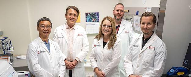 The NRIBBB research team standing in lab coats.