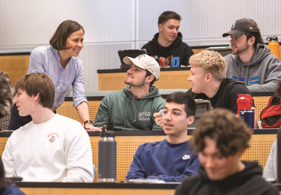 Teacher talking to students in a classroom